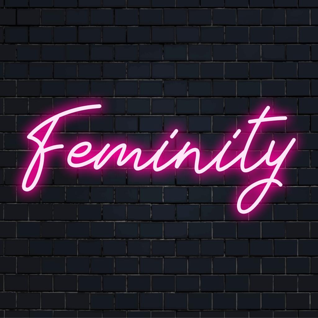 Op maat gemaakt LED-neonbord met de titel Feminity, met elegante rondingen en levendige roze tinten, ideaal voor een chique interieur.