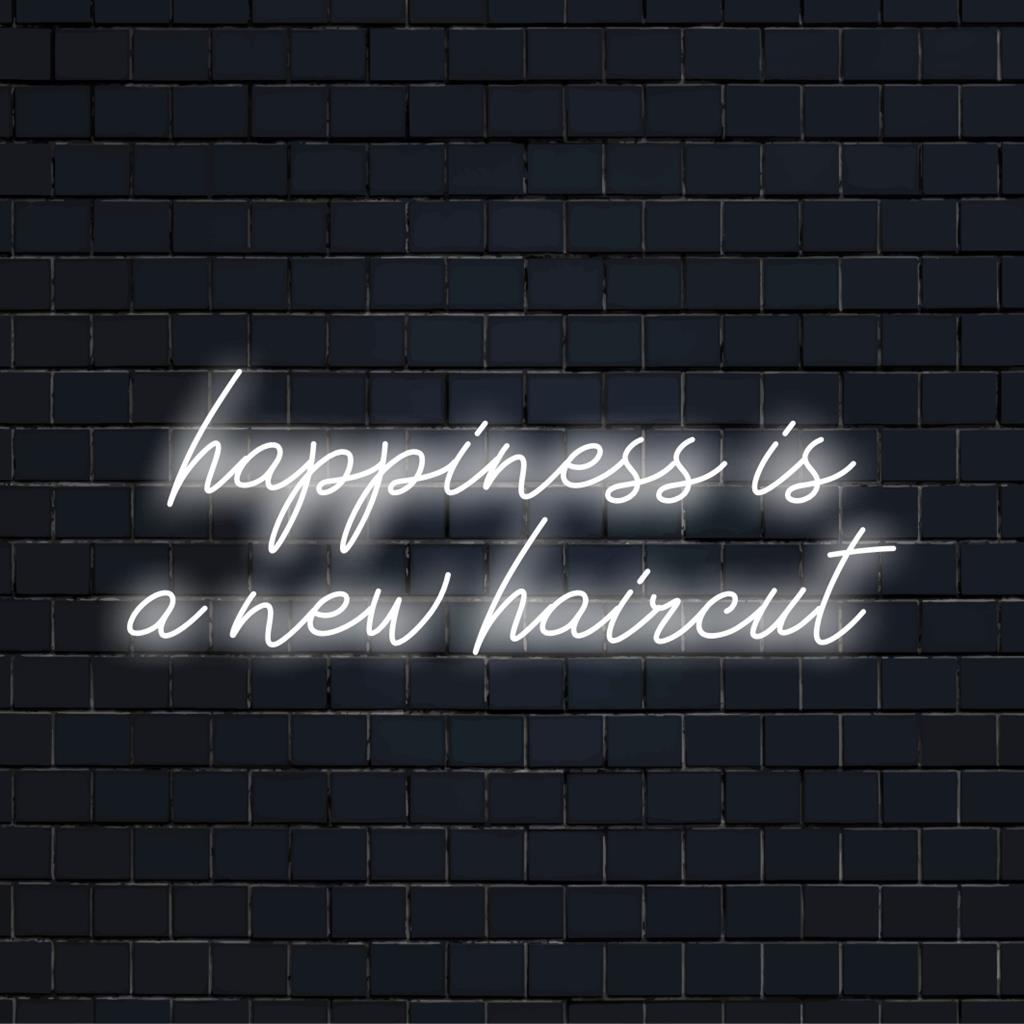 Felgekleurde, stijlvolle LED-neonreclame met de tekst Happiness Is A New Haircut, perfect voor een modern interieur.