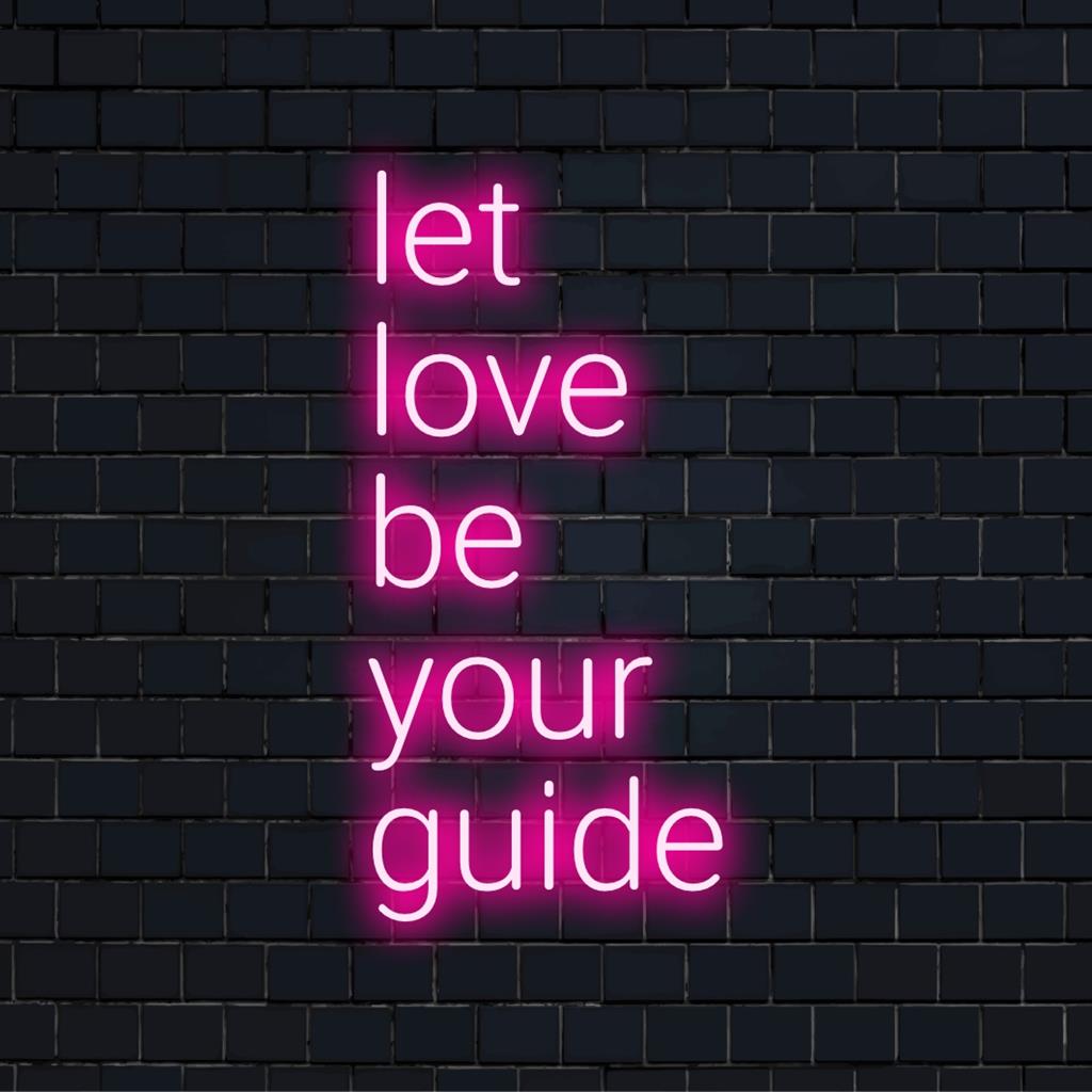 Levendig LED-neonbord met de tekst Let Love Be Your Guide. Kunst en licht worden gecombineerd om ruimtes te verlichten met positieve energie.