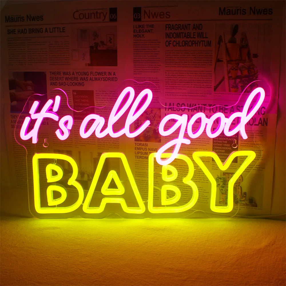 De afbeelding toont een levendig "It's All Good Baby" LED-neonbord, uitgevoerd in een strak, modern scriptlettertype.