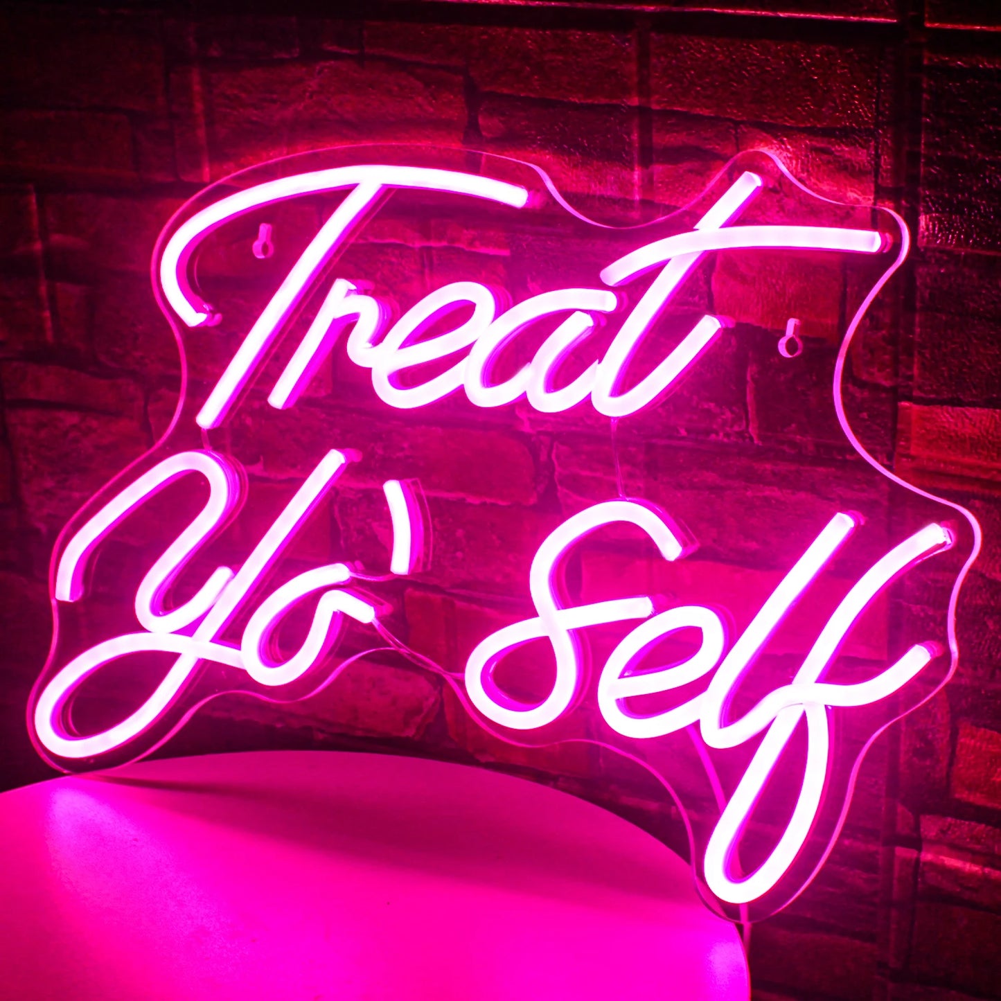 Op de afbeelding staat een opvallend led-neonbord met de tekst "Treat Yo' Self" in een stijlvol, cursief lettertype.