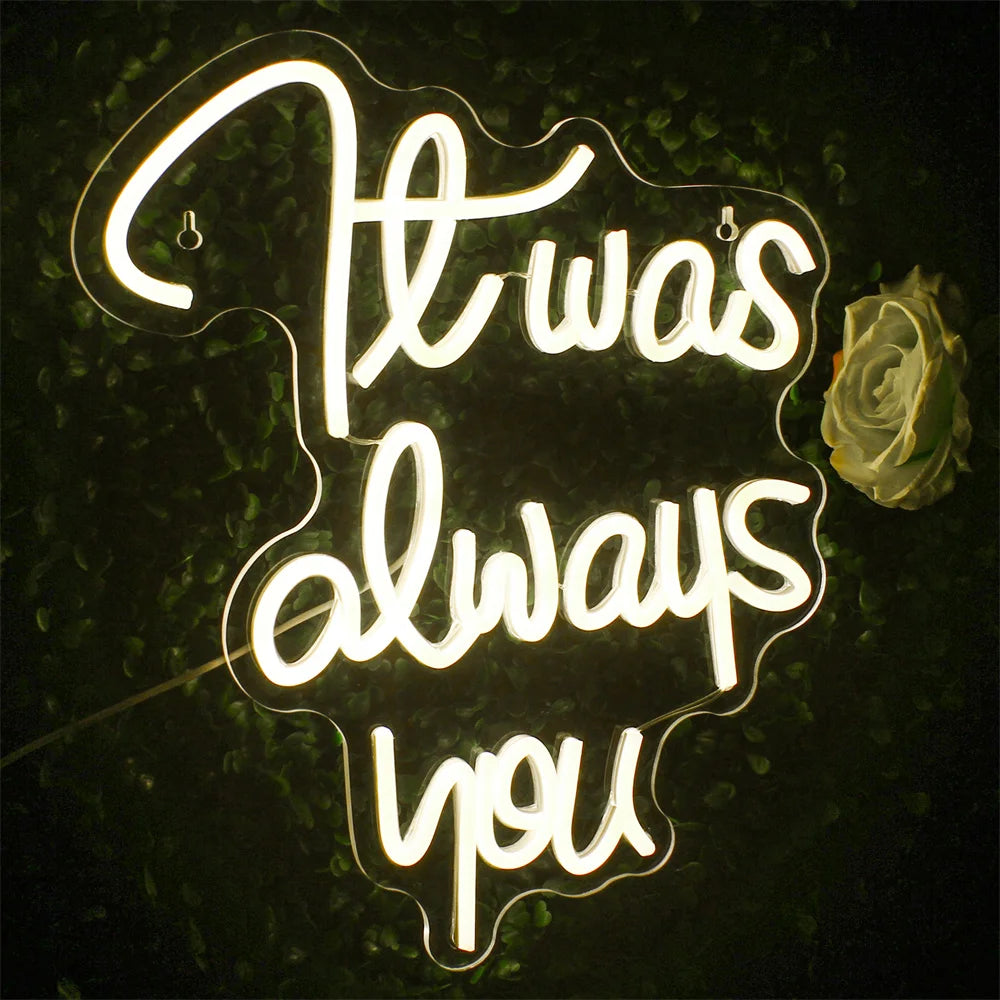 Een levendig LED-neonbord met de tekst 'It was always you' in elegante, cursieve letters.