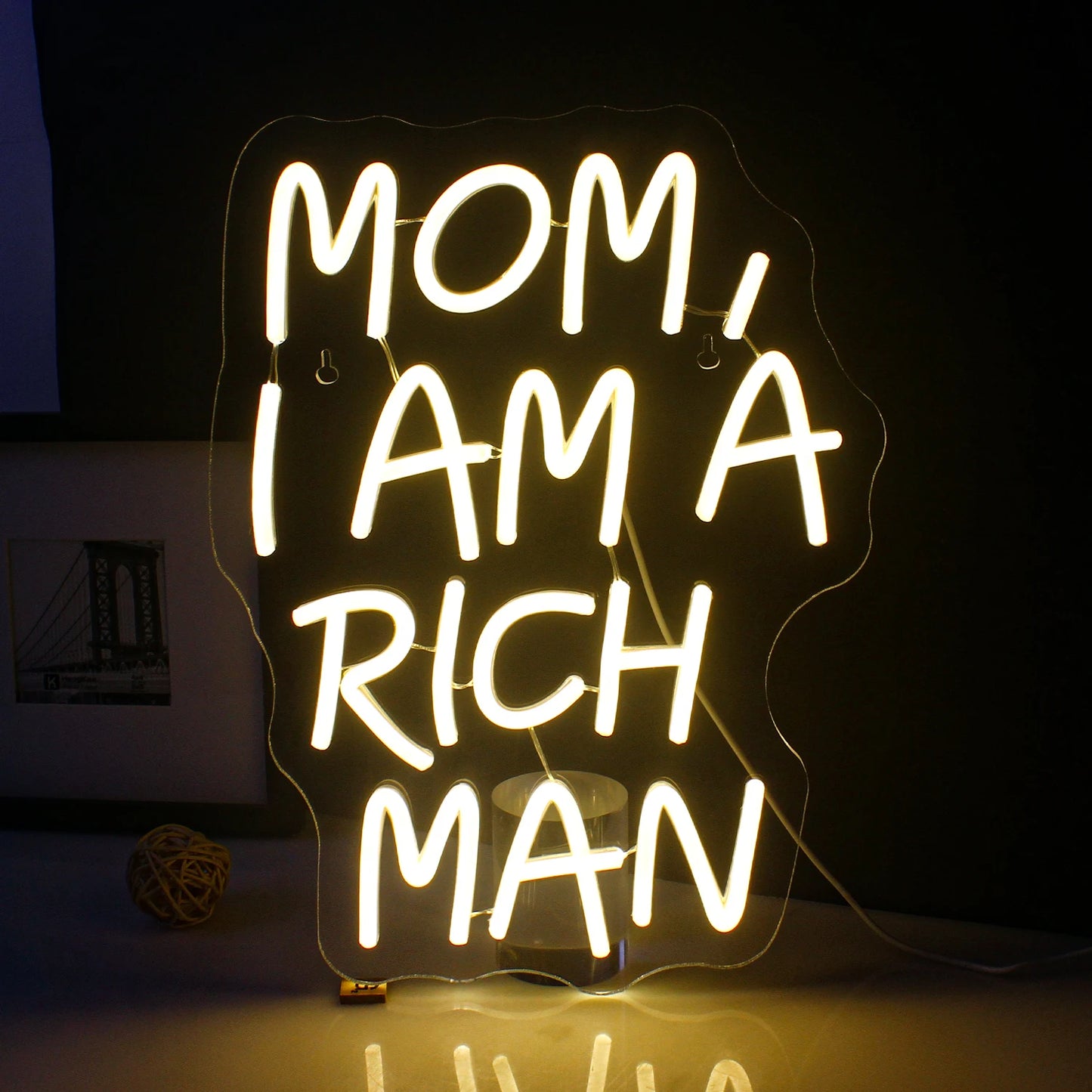 Een opvallend LED-neonbord met de tekst "Mom I Am A Rich Man" in elegante, cursieve letters.