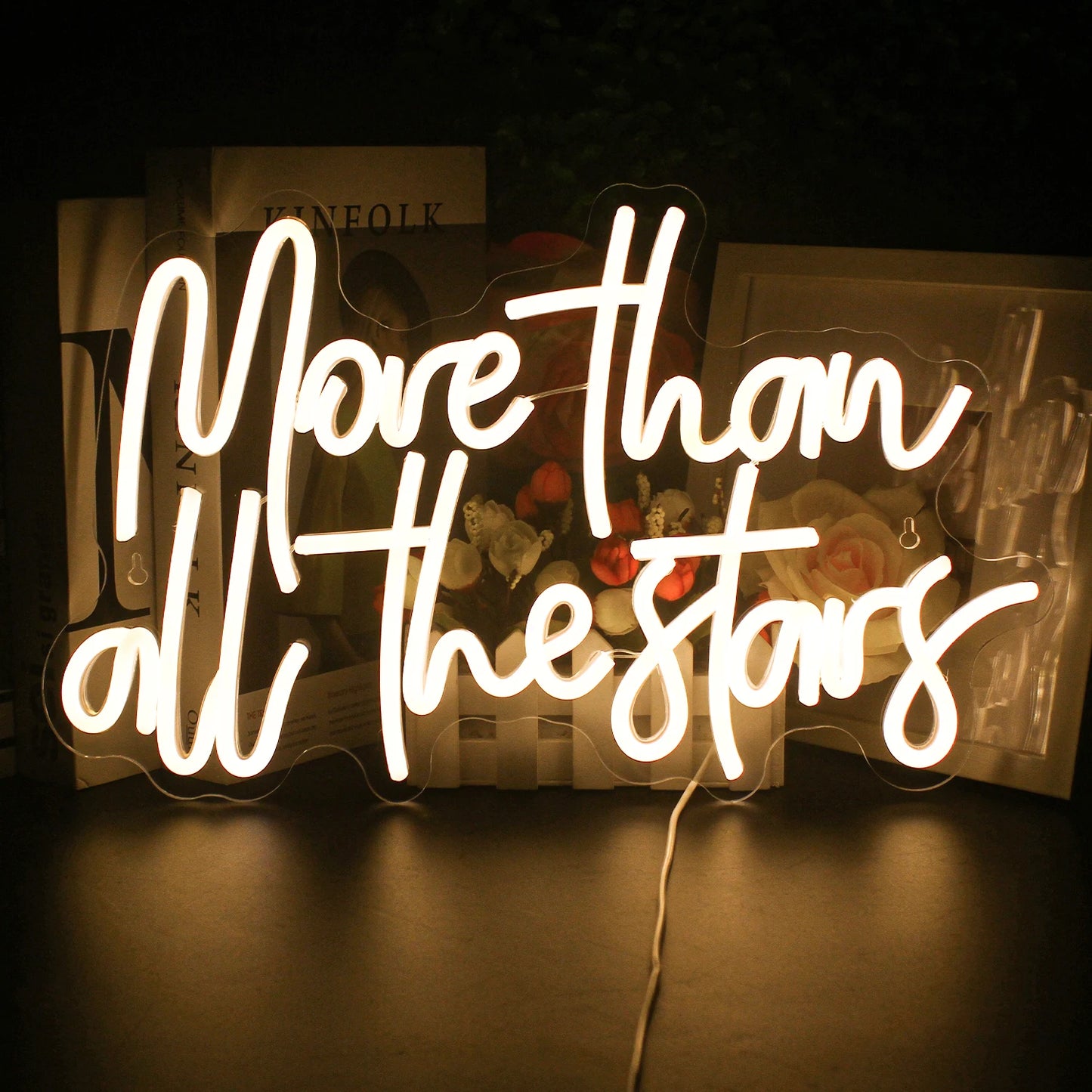 Op de afbeelding staat een handgemaakt LED-neonbord met de tekst "More Than All The Stars" in elegante, cursieve letters.