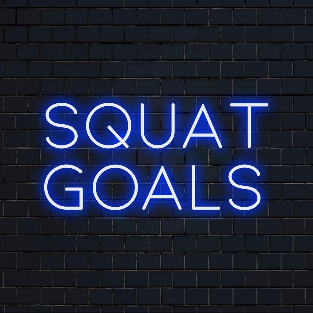 Op maat gemaakt LED-neonbord met de tekst Squat Goals, verlicht met levendig licht. Perfect als decoratie in de sportschool of als motiverende wandkunst.