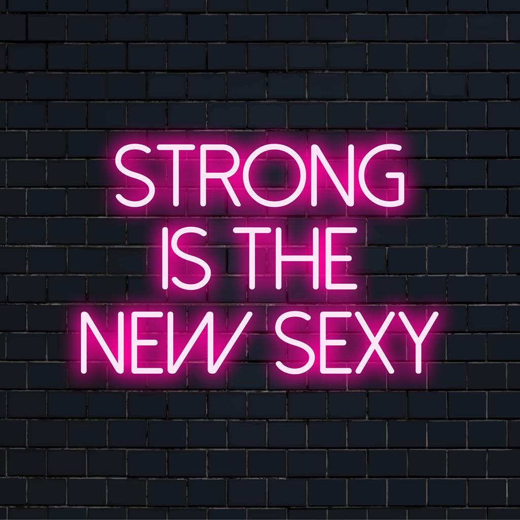 LED-neonreclame met de tekst Strong Is The New Sexy; levendige, motiverende wandkunst die oplicht in felle kleuren.