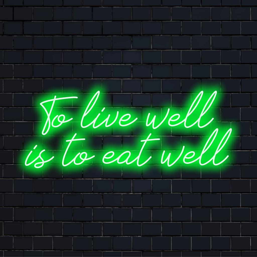Het levendige To Live Well Is To Eat Well LED-neonbord is op maat gemaakt en is perfect voor het verlichten van ruimtes met een stijlvolle neon-esthetiek.