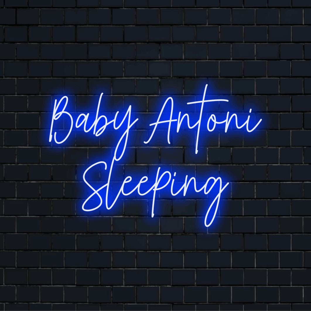 Baby Antoni Sleeping Custom Name Neon Sign, neon text light against black brick wall