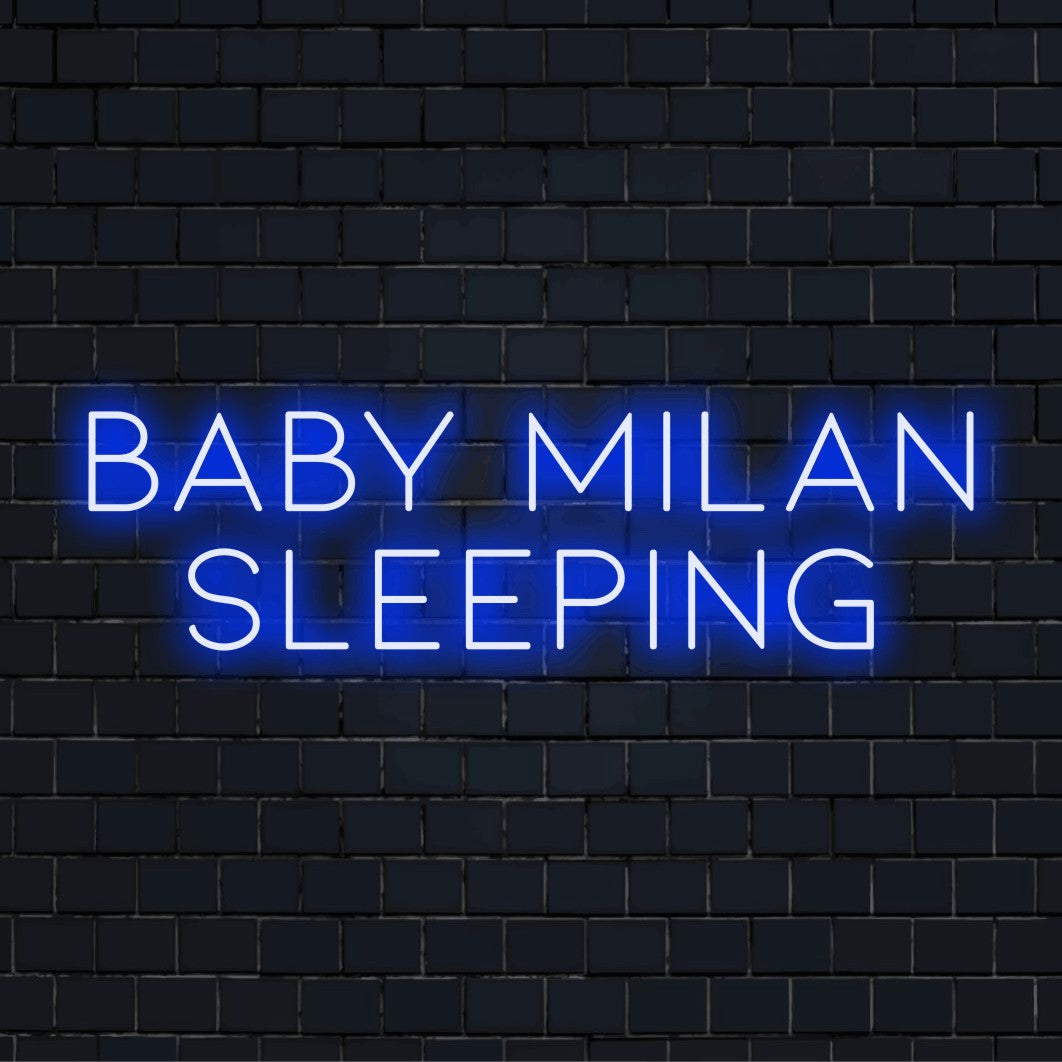 Baby Milan Sleeping Custom Name Neon Sign, glowing wall decor on dark brick wall