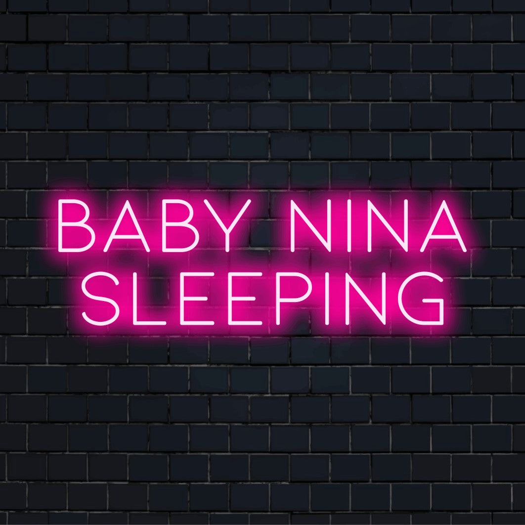 Baby Nina Sleeping Custom Name Neon Sign, neon text light against black brick wall