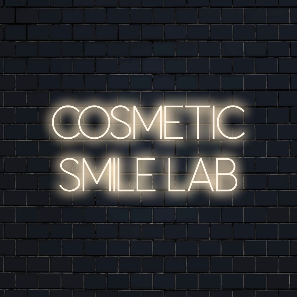 Cosmetic Smile Lab Neon Light with bright neon lettering on dark brick background