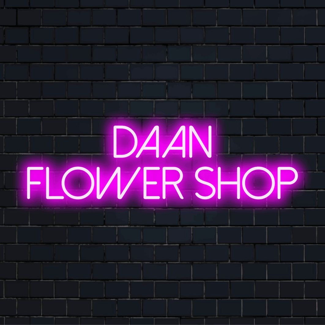 Daan Flower Shop Personalized LED Neon Sign, glowing lettering on dark brick background