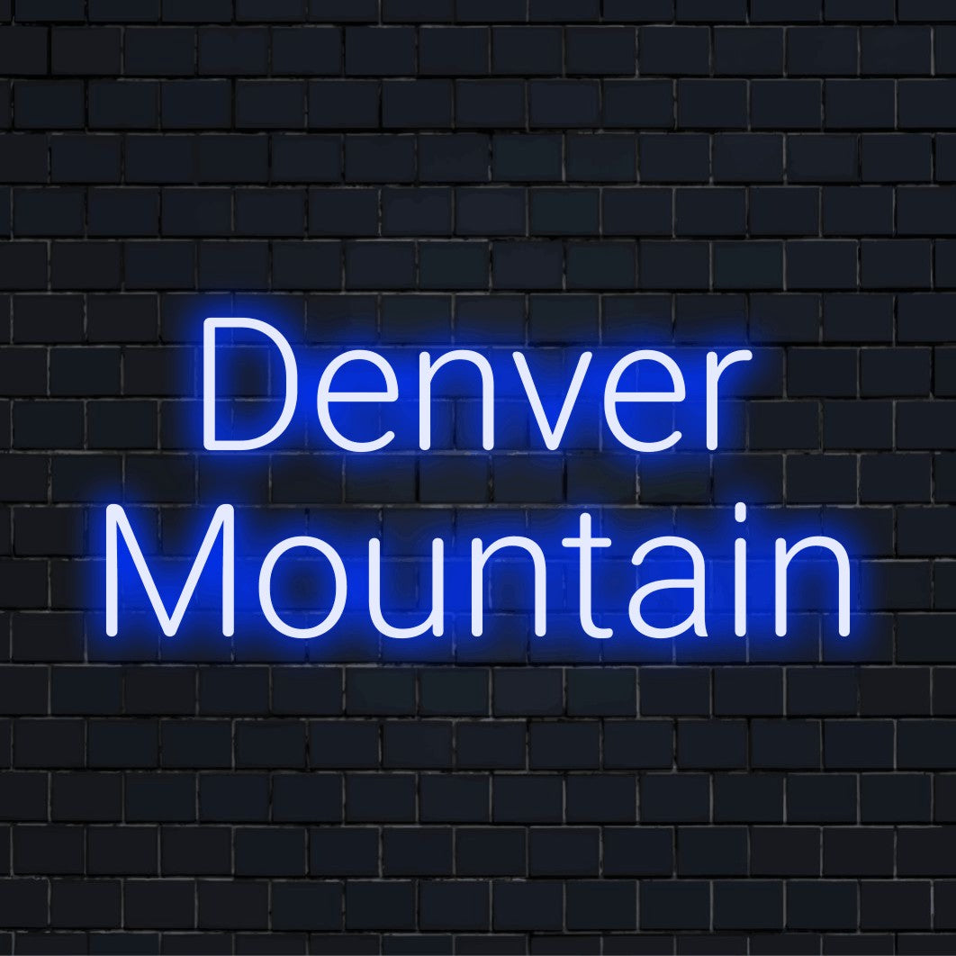 Denver Mountain Neon Light with glowing lettering against black brick wall