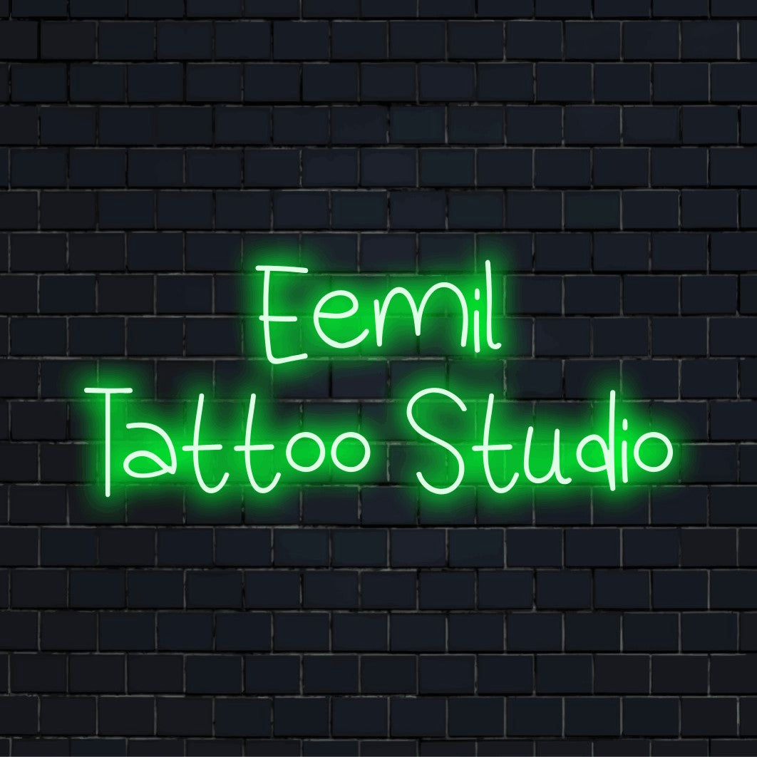 Eemil Tattoo Studio Personalized Neon Light with glowing wall decor against brick backdrop