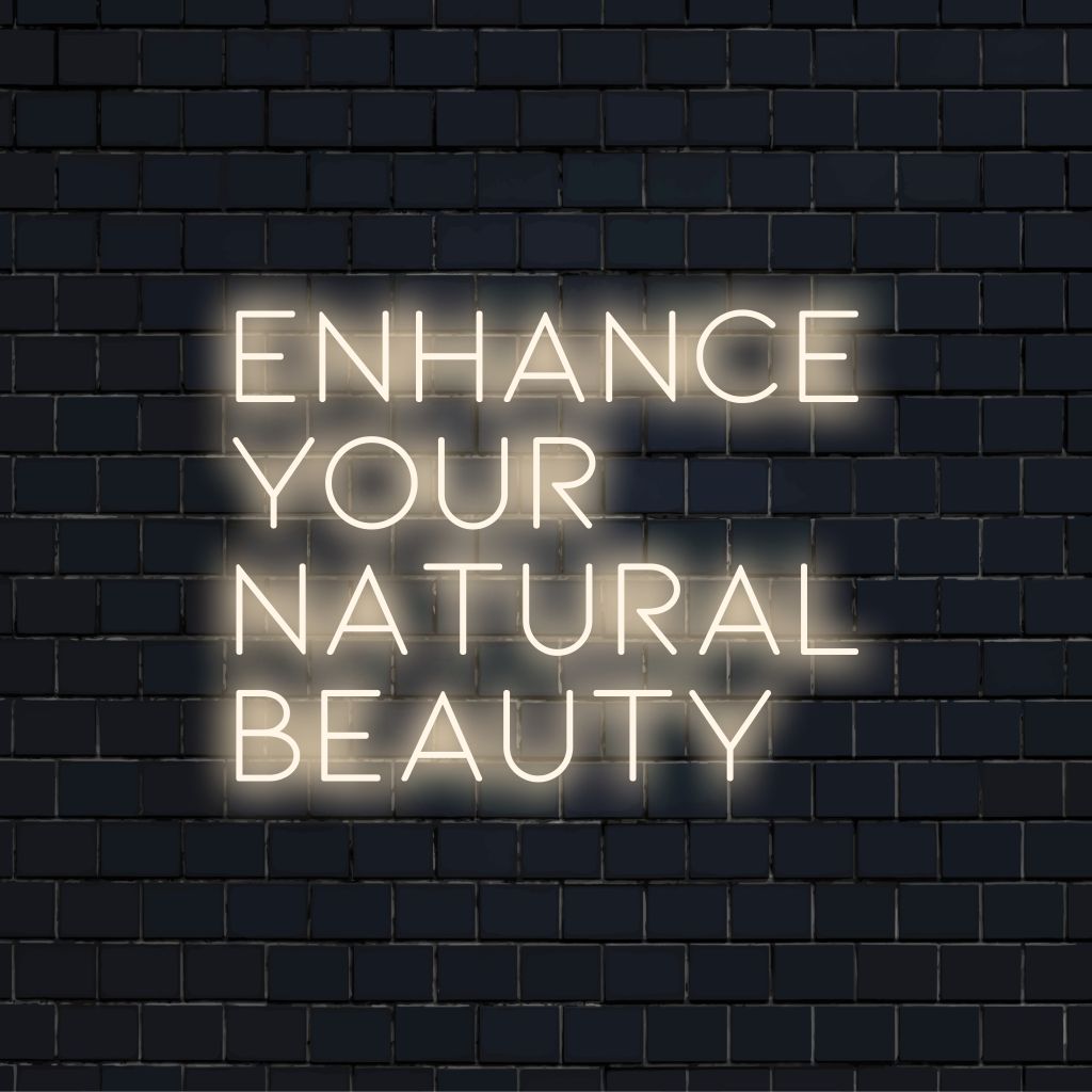 Enhance Your Natural Beauty Neon Sign, glowing neon text on dark brick background