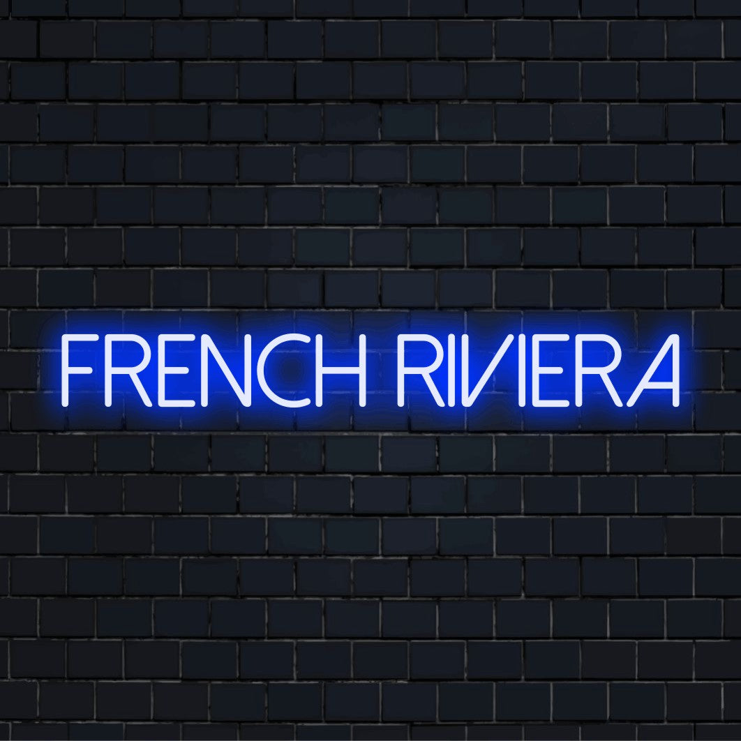 French Riviera LED Neon Sign, glowing neon text on black brick background
