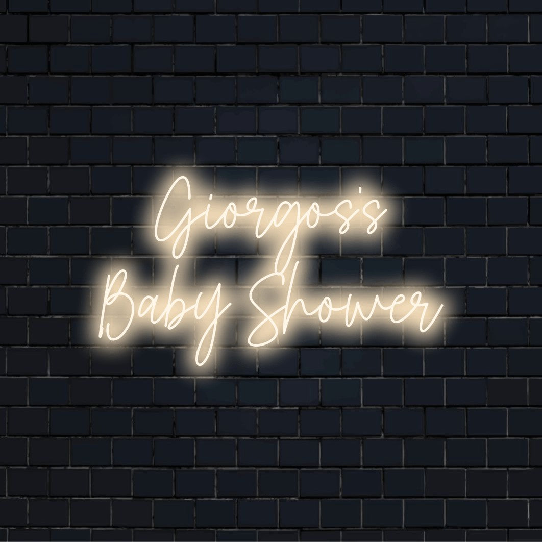 Giorgos_s Baby Shower Custom Name Neon Sign, glowing wall decor against black brick wall