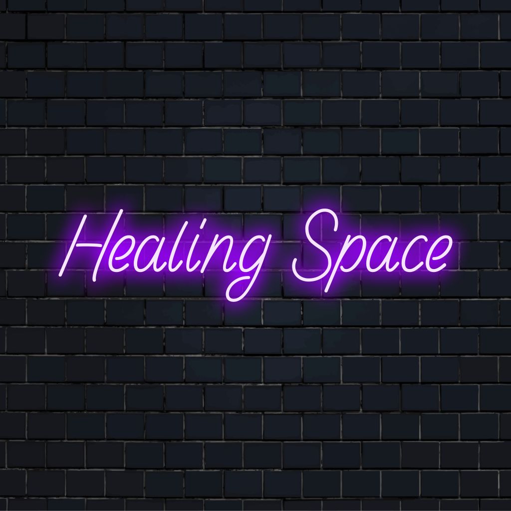Healing Space Neon Light with glowing lettering against brick backdrop