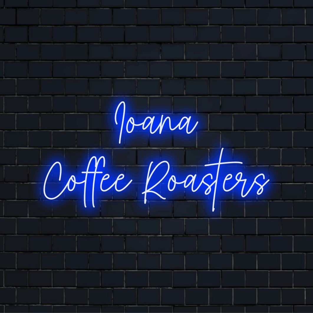 Ioana Coffee Roasters Personalized Neon Light with glowing wall decor against black brick wall