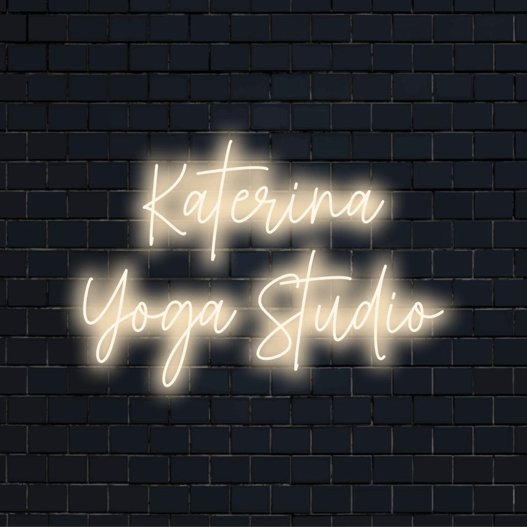 Katerina Yoga Studio Personalized LED Neon Sign, bright neon lettering against brick backdrop