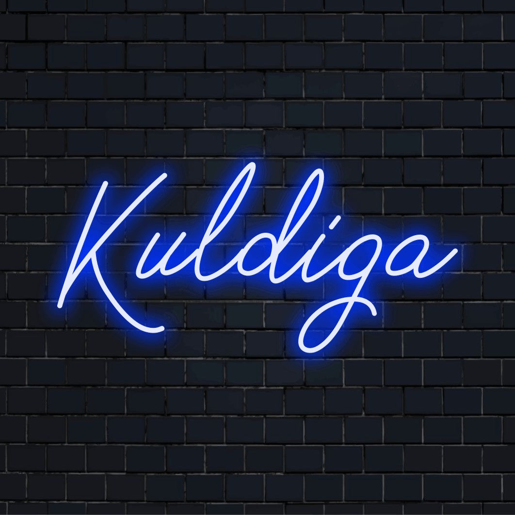 Kuldiga Neon Sign, glowing lettering on dark brick wall