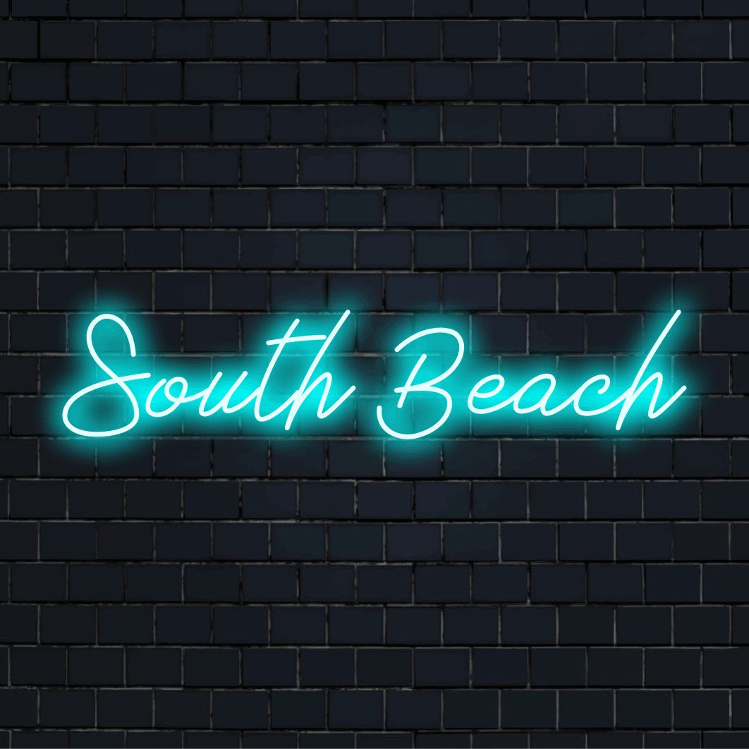 South Beach Neon Light with glowing neon text against black brick wall