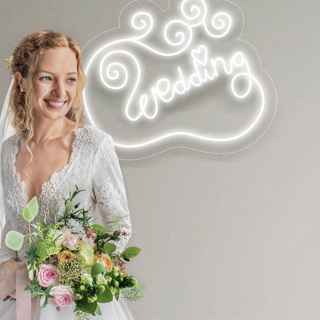 Een romantisch neonbord met het woord 'Wedding' in sierlijke, cursieve letters.