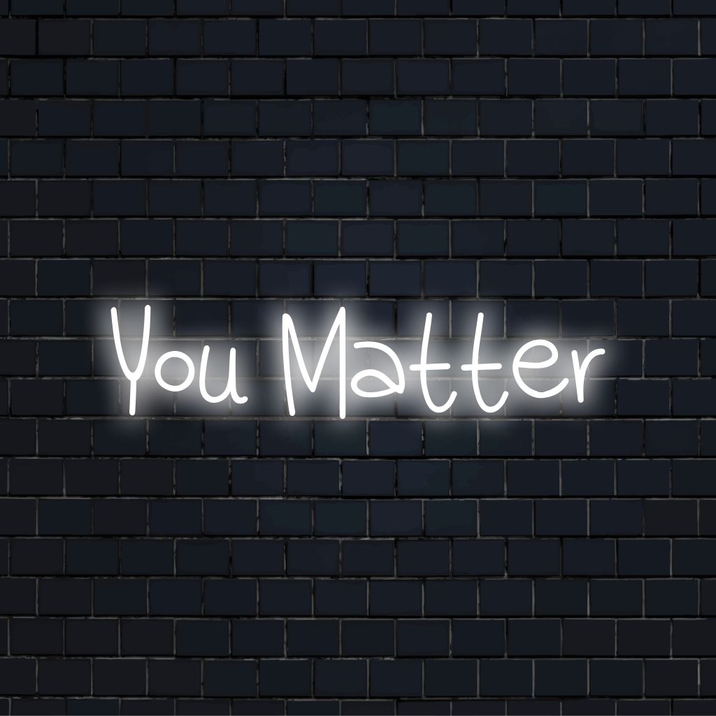 You Matter Neon Sign, glowing lettering on dark brick wall