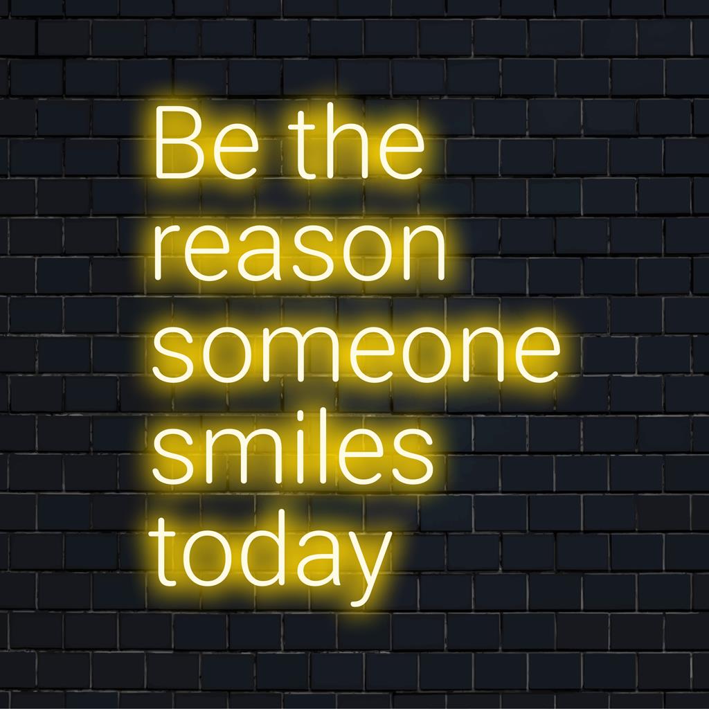 Handgemaakt LED-neonbord met de opbeurende quote 'Wees de reden dat iemand vandaag lacht'; op maat gemaakte neonlichtdecoratie.