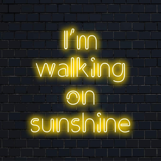 Custom-made LED neon sign reads I'm Walking On Sunshine, radiating vibrant ambient light for home decor.