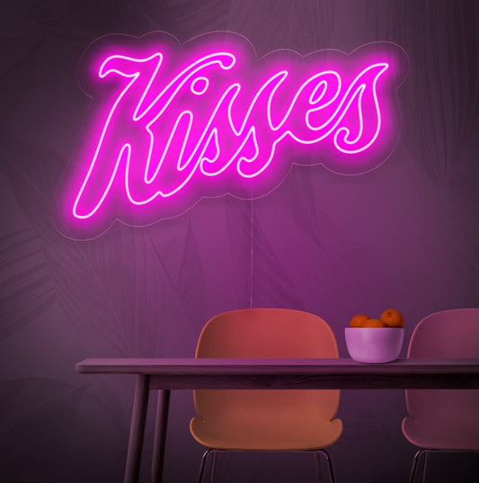 An illuminated neon sign featuring the word 'Kisses', symbolizing love and romance, adding a touch of passion and charm to any space