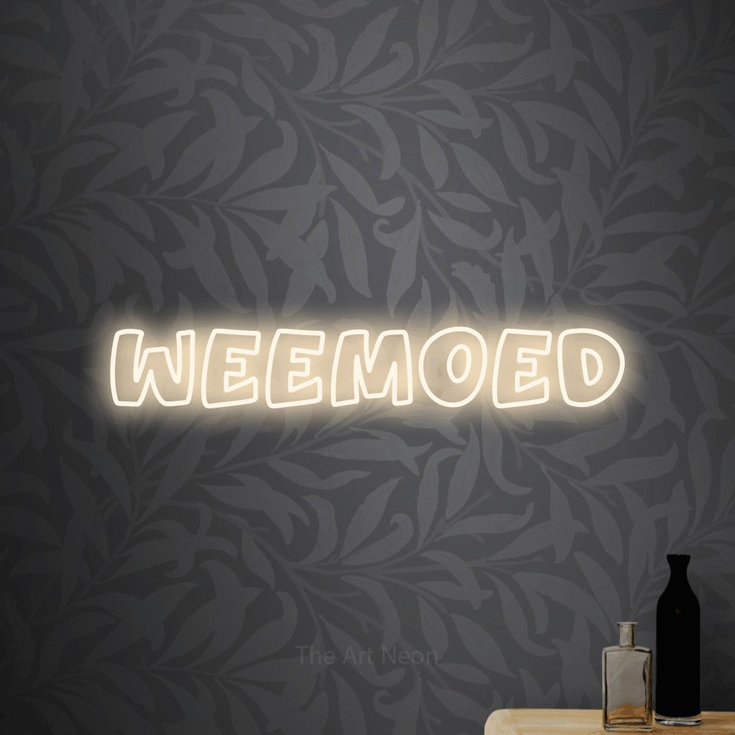 LED neon sign reading “weemoed”, arranged in a single line.