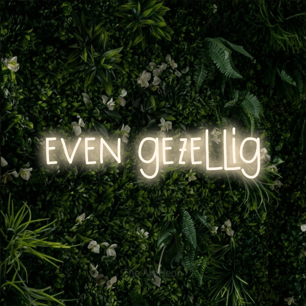 LED neon sign reading “even gezellig”, arranged in a single line.