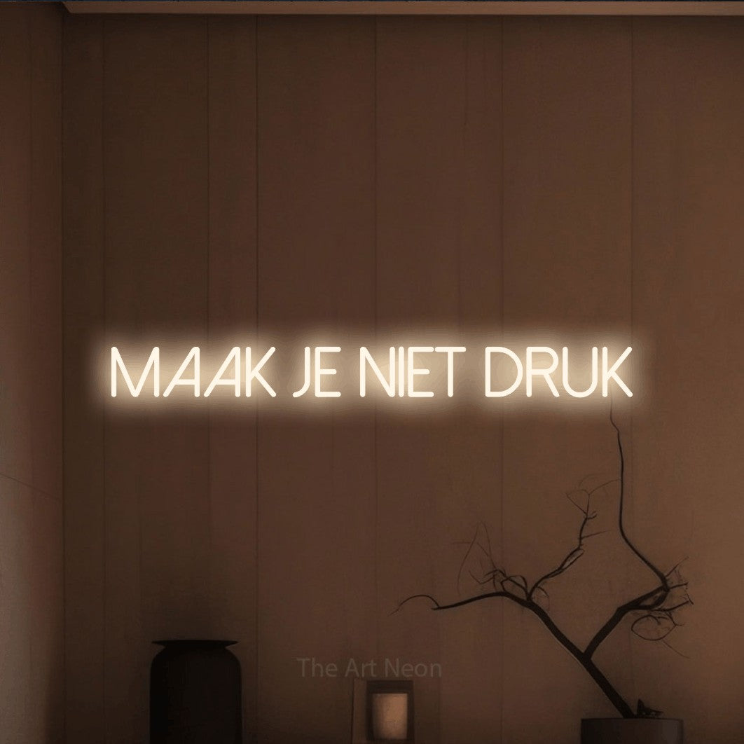 LED neon sign reading “maak je niet druk”, arranged in a single line.