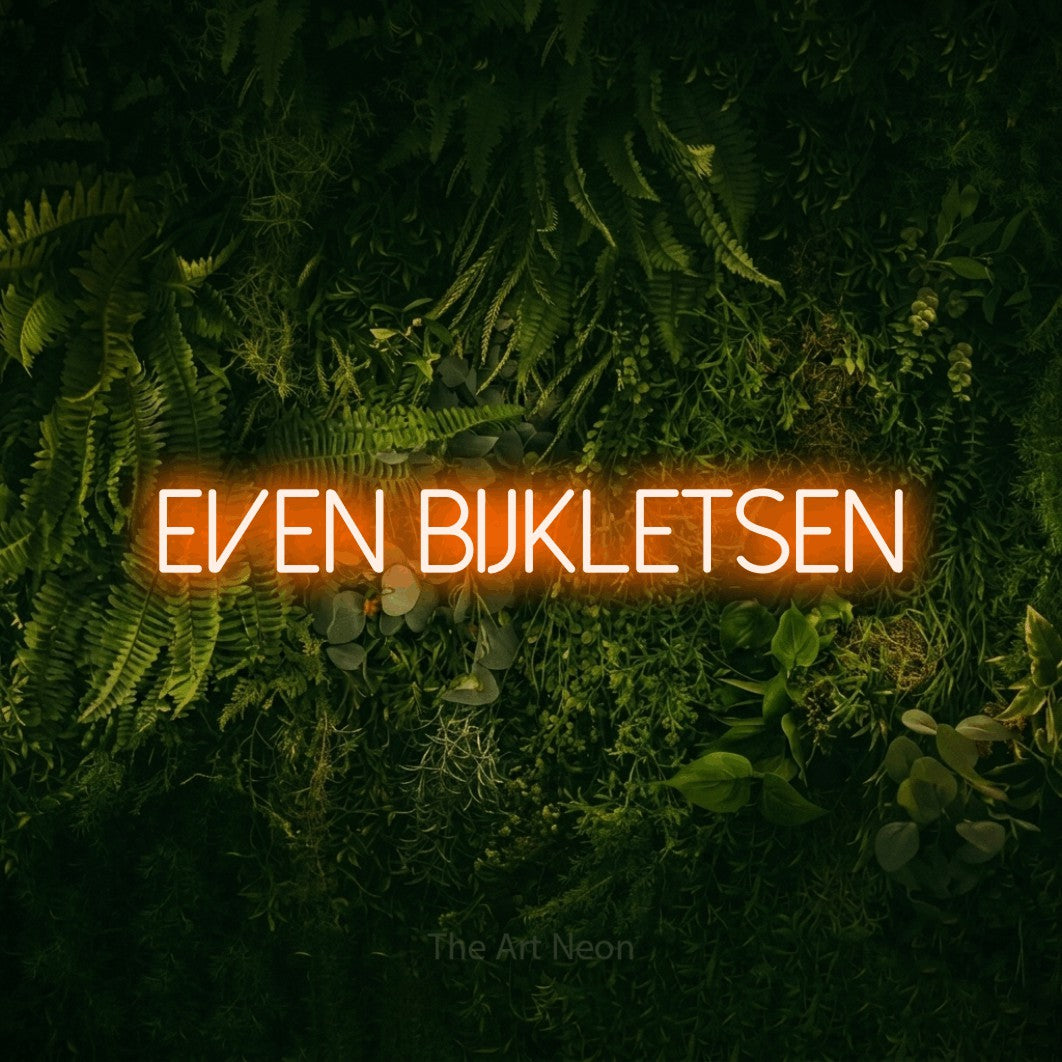 LED neon sign reading “EVEN BIJKLETSEN”, arranged in a single line.