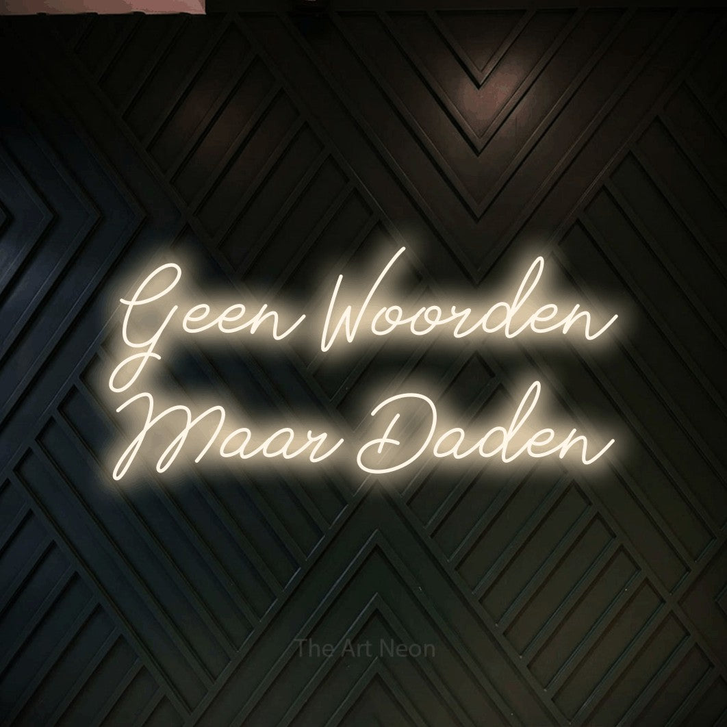 LED neon sign reading “Geen Woorden Maar Daden”, arranged in 2 lines.