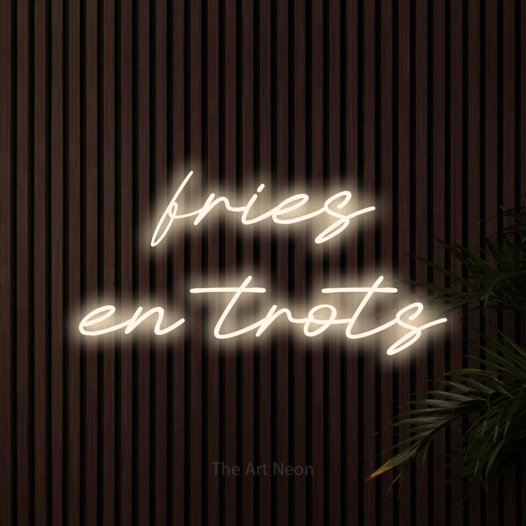 LED neon sign reading “fries en trots”, arranged in 2 lines.