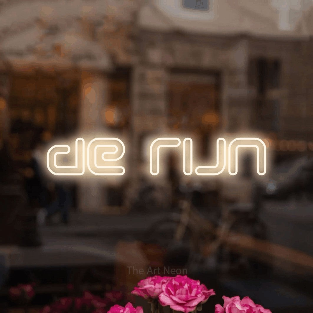 LED neon sign reading “de rijn”, arranged in a single line.