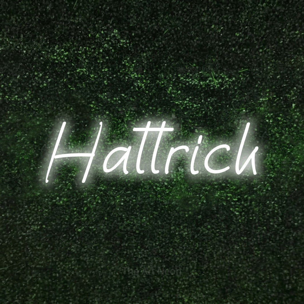 LED neon sign reading “Hattrick”, arranged in a single line.