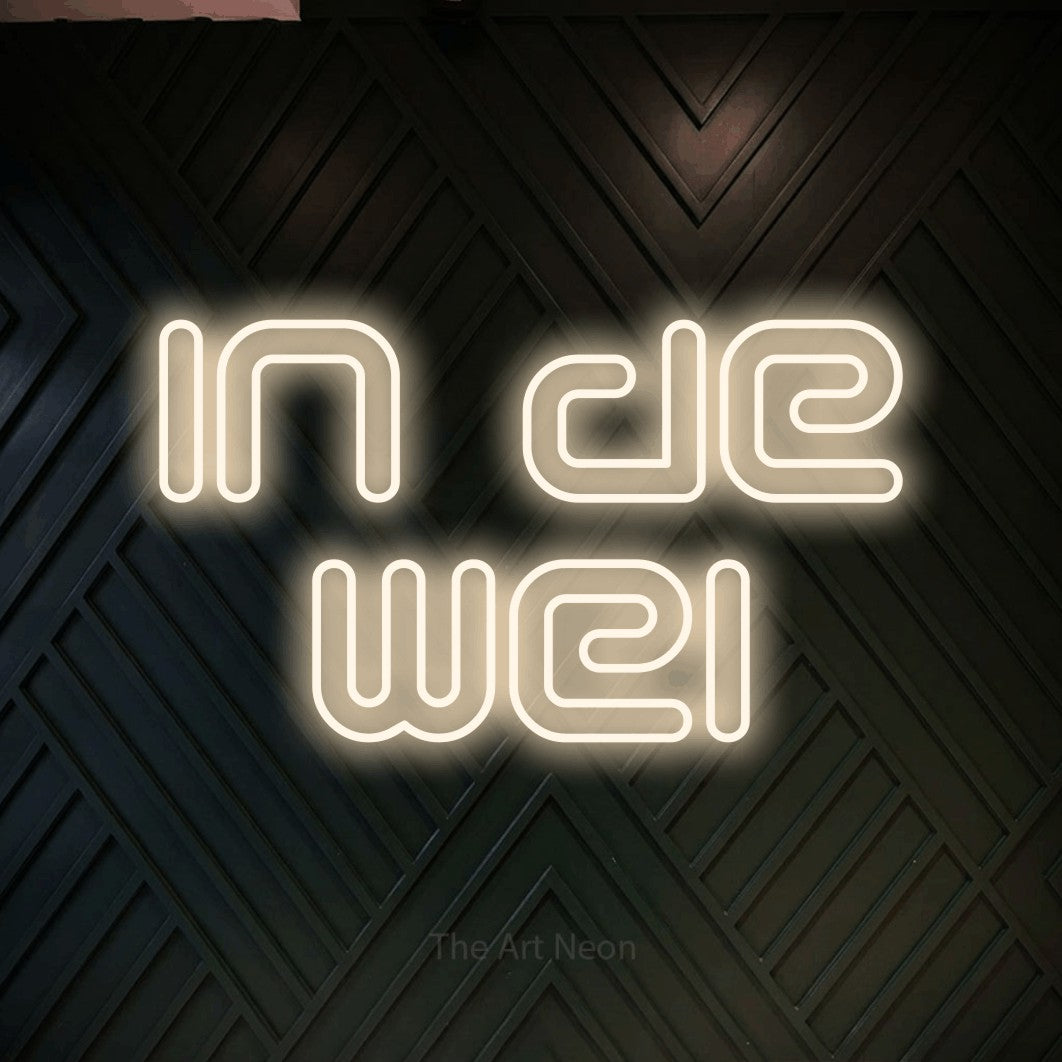 LED neon sign reading “In de wei”, arranged in 2 lines.