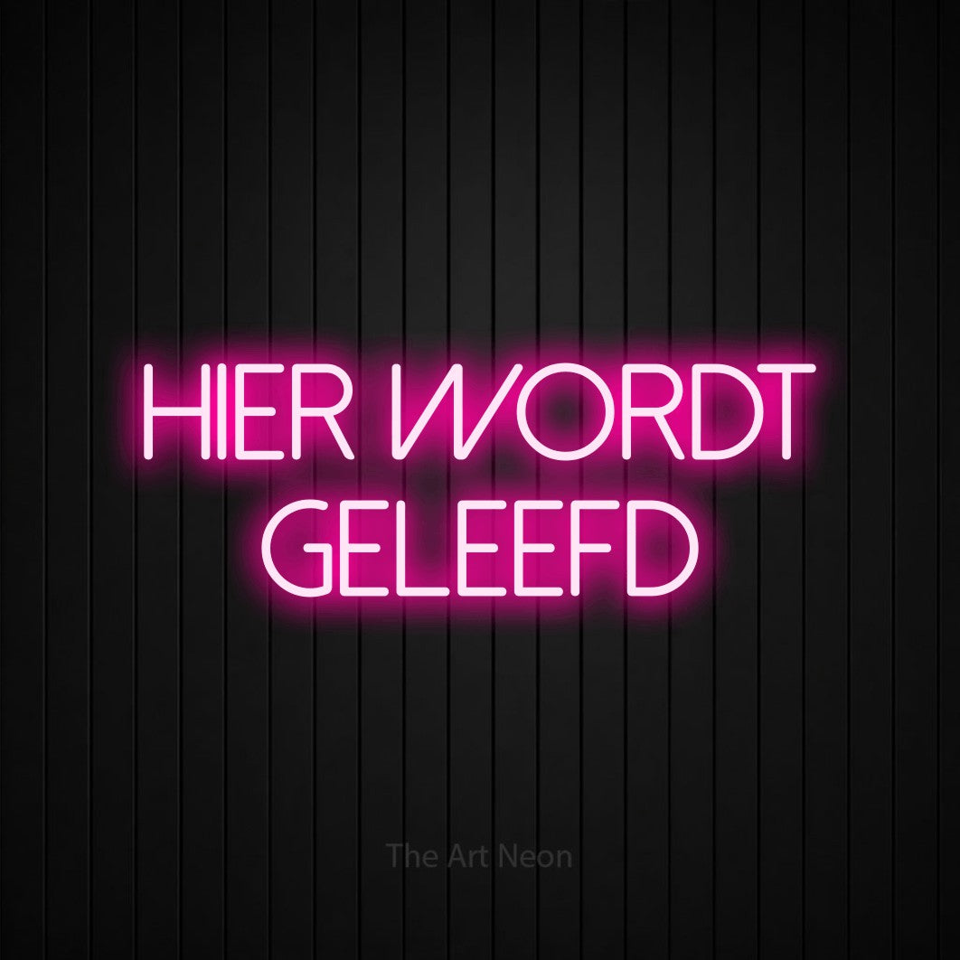 LED neon sign reading “HIER WORDT GELEEFD”, arranged in 2 lines.