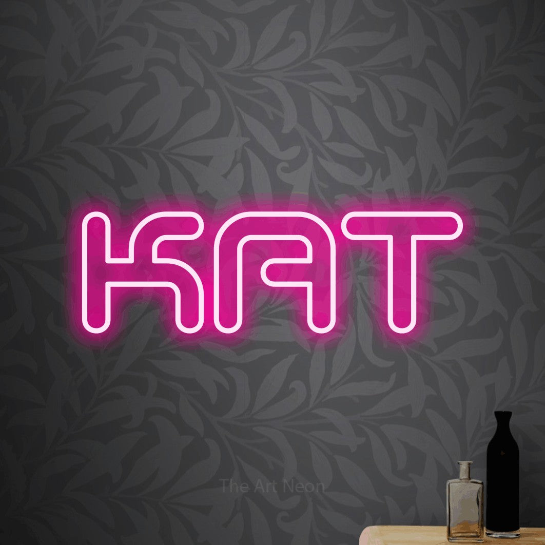 LED neon sign reading “KAT”, arranged in a single line.