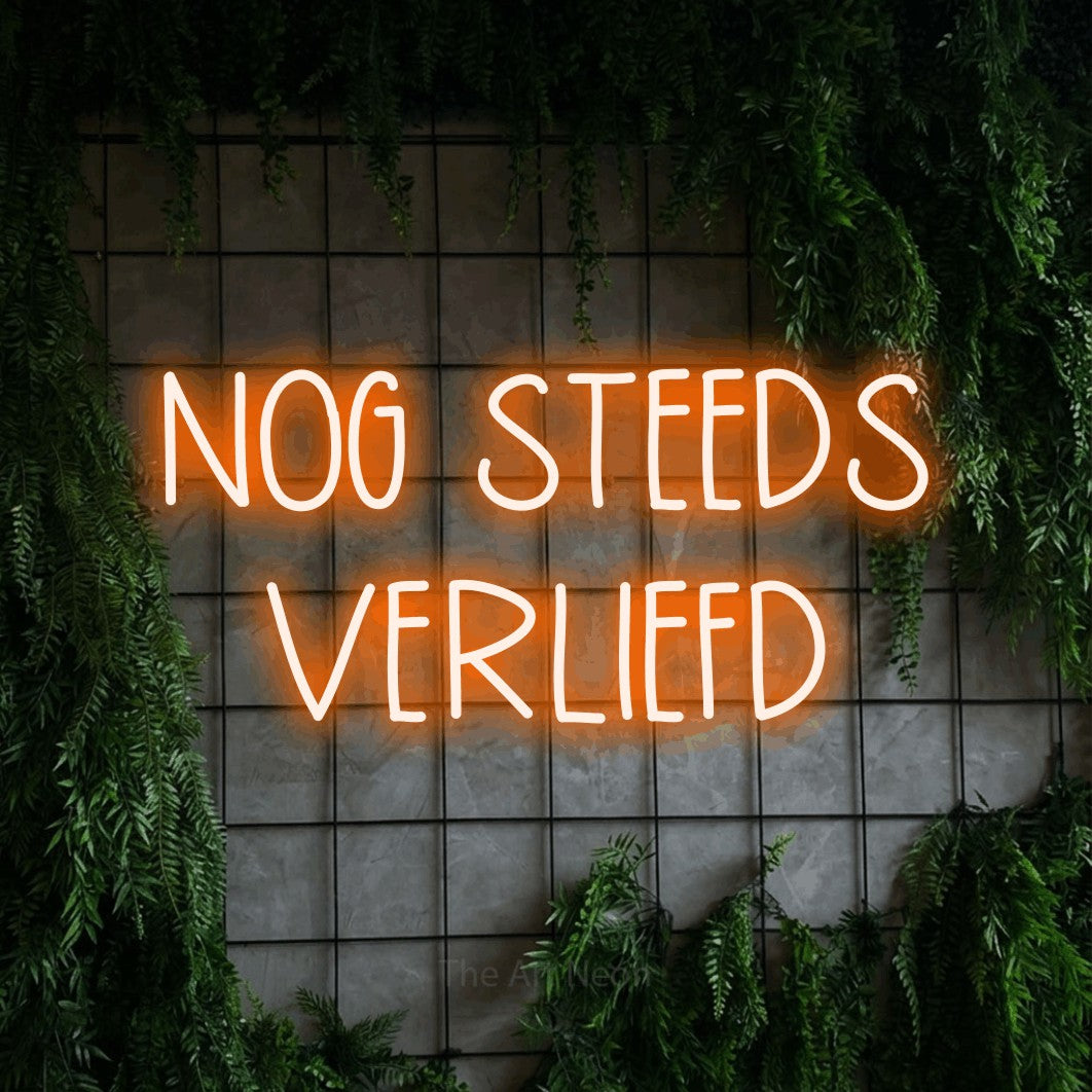 LED neon sign reading “NOG STEEDS VERLIEFD”, arranged in 2 lines.