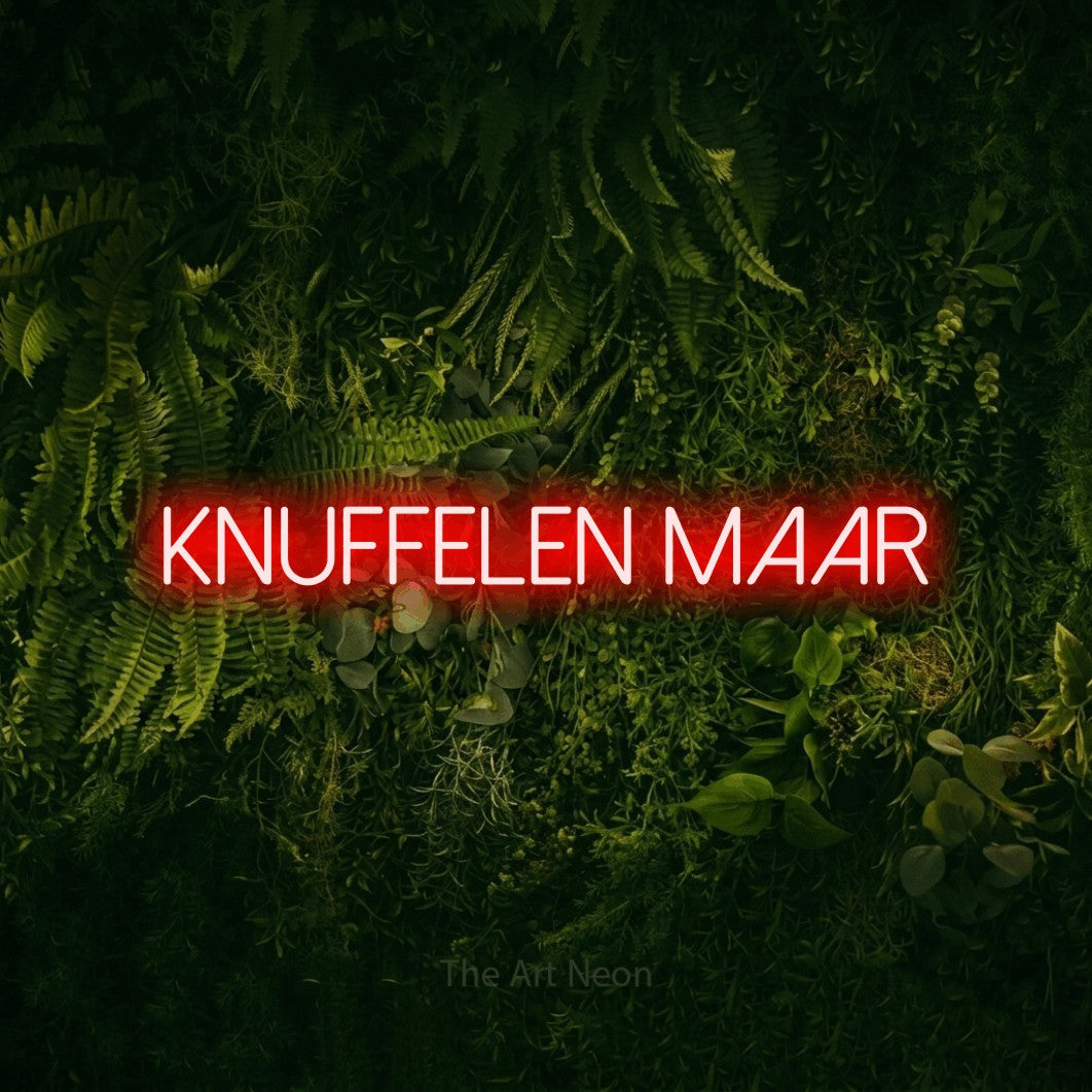 LED neon sign reading “knuffelen maar”, arranged in a single line.