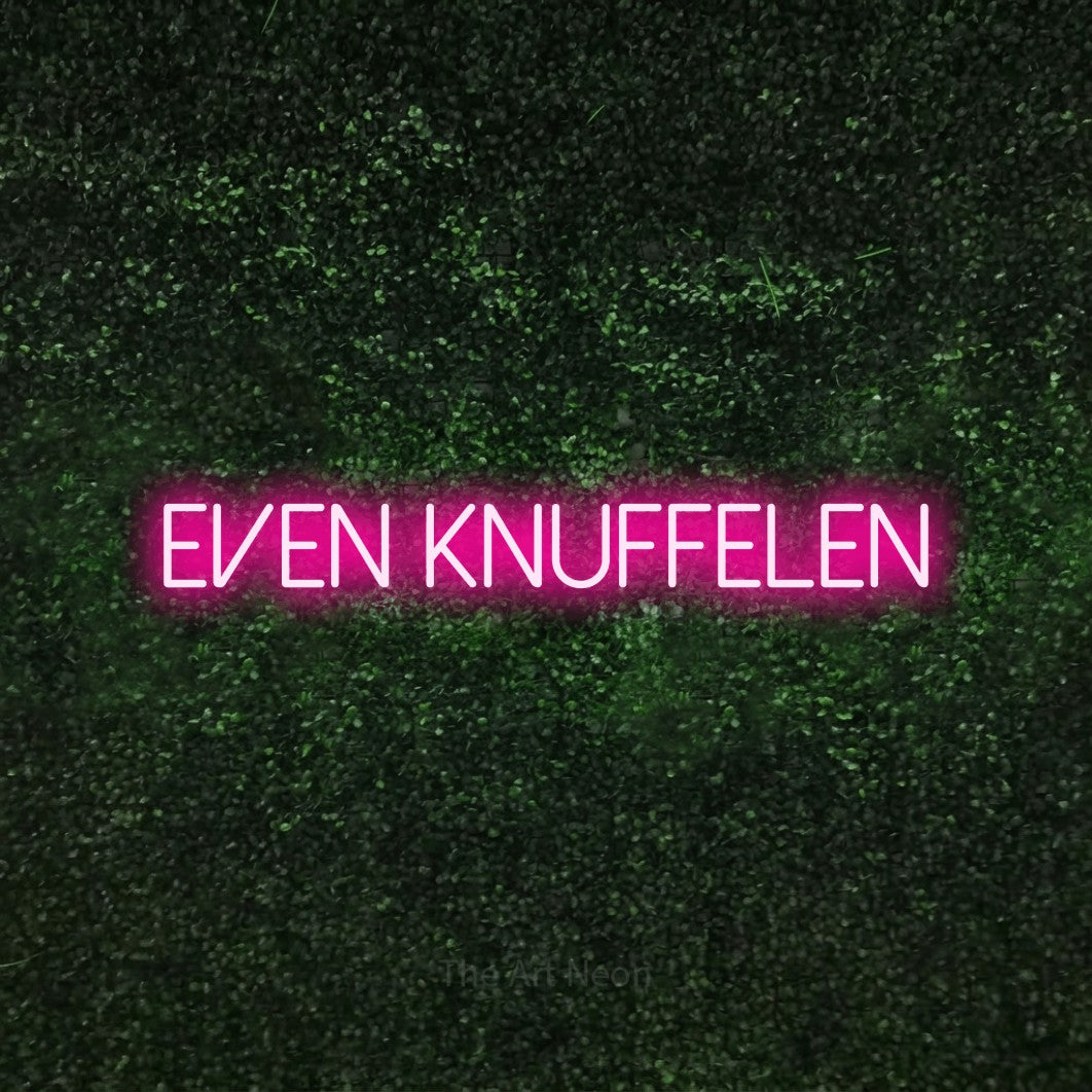 LED neon sign reading “EVEN KNUFFELEN”, arranged in a single line.
