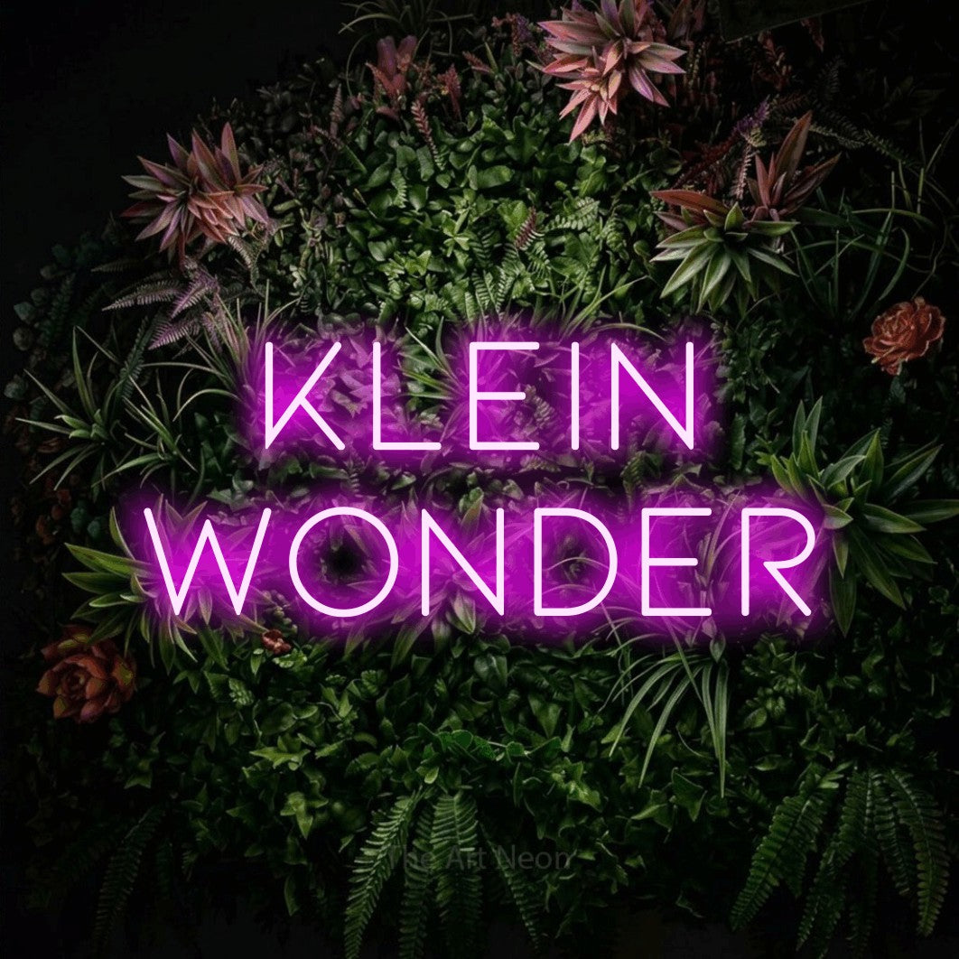 LED neon sign reading “Klein Wonder”, arranged in 2 lines.