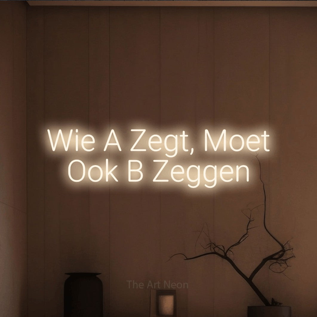 LED neon sign reading “Wie A Zegt, Moet Ook B Zeggen”, arranged in 2 lines.