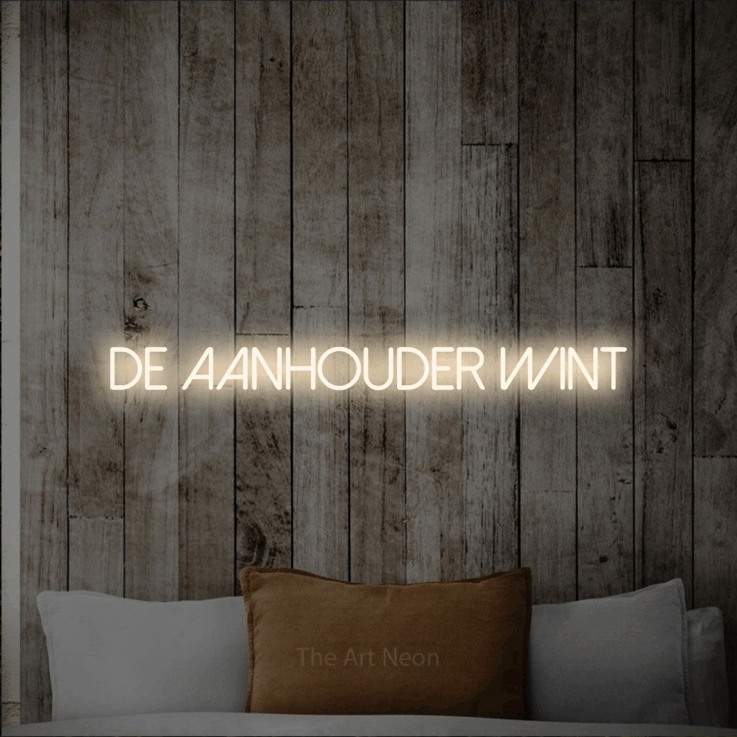 LED neon sign reading “De Aanhouder Wint”, arranged in a single line.