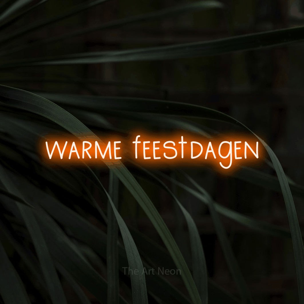 LED neon sign reading “warme feestdagen”, arranged in a single line.