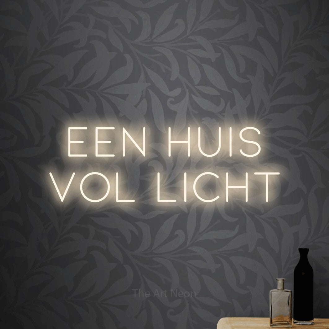 LED neon sign reading “een huis vol licht”, arranged in 2 lines.